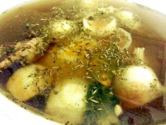 Place the chicken in the slow cooker. Add onions and other root vegetables, poultry seasonings and peppercorns. Add your favorite spices and herbs. Garlic cloves too!